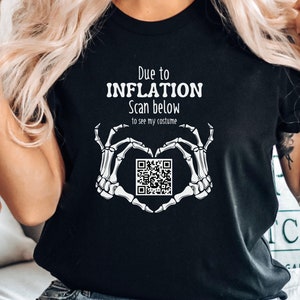 May include: Black t-shirt with white text that reads "Due to INFLATION Scan below to see my costume" and a skeleton hand heart shape with a QR code in the center.