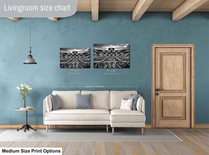 a living room with a white sofa, a wooden door, and a hanging light fixture. Above the sofa, there is a size chart for artwork, indicating the dimensions of the paintings.