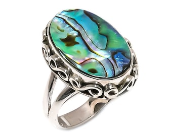 Könnte beinhalten: Ein silberner Ring mit einem ovalen Einlegeteil aus Abalone-Muschel. Die Muschel hat ein grünes, blaues und irisierendes Farbmuster.