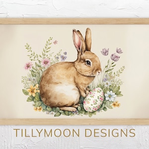 May include: A watercolor painting of a brown rabbit sitting in a bed of colorful flowers, holding a decorated Easter egg. The background is a light beige.