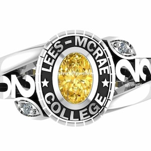 May include: A silver class ring with a black band and a yellow gemstone. The ring features the words "Lees-McRae College" and the year "2022" on the band.