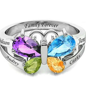 May include: Silver ring with a butterfly design featuring four gemstones in purple, blue, green, and orange. The ring is engraved with the words "Family Forever" and four names: Madison, Audrey, James, and Cathy.