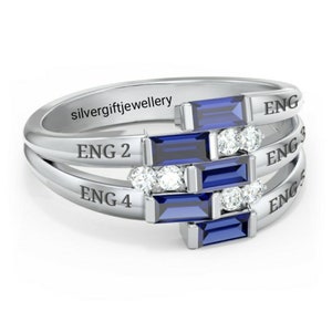 May include: A silver ring with five blue sapphire stones and small clear stones. The ring has the words "ENG 1", "ENG 2", "ENG 3", "ENG 4", and "ENG 5" engraved on it.