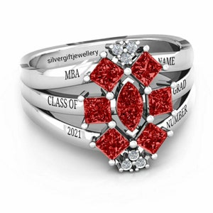 May include: Silver ring with red and white gemstones. The ring has the words "MBA", "CLASS OF 2021", "NAME", "GRAD", and "NUMBER" engraved on it.