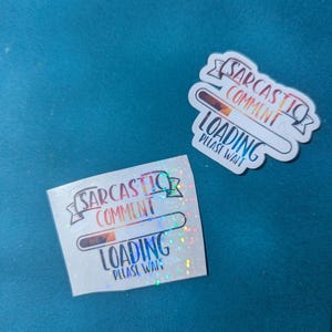 Könnte beinhalten: Zwei Aufkleber mit dem Text "Sarcastic Comment Loading Please Wait". Einer ist rechteckig mit holografischem Finish, der andere ein weißer, gestanzter Aufkleber. Beide Aufkleber haben eine Ladebalken-Grafik.