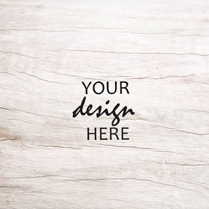 May include: A light wood background with the text "YOUR design HERE" in black.