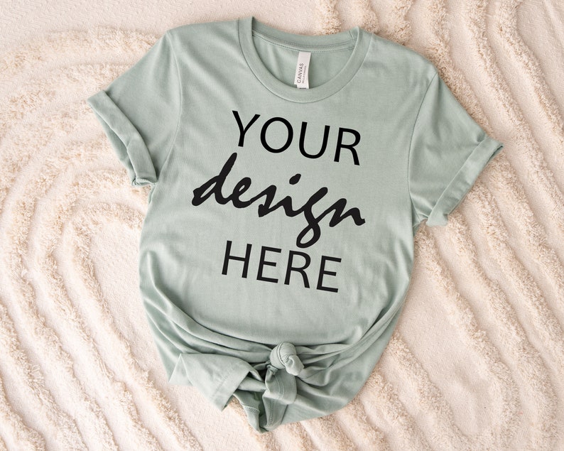 May include: A light green t-shirt with the text "YOUR design HERE" printed on the front.