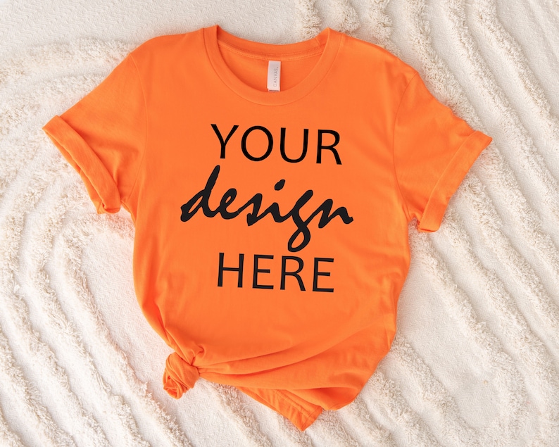 May include: Orange t-shirt with the text "YOUR design HERE" printed in black.