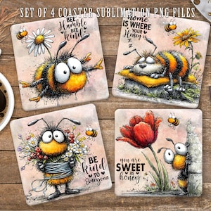 May include: A set of four square coasters with bee-themed illustrations. Each coaster displays a unique bee design with phrases such as "Bee Humble Bee Kind" and "Home is where your honey is." The coasters are set on a wooden surface.