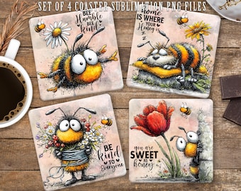 May include: Set of four square coasters with whimsical bee illustrations. Each coaster features a different bee design with text like "Bee Humble Bee Kind" and "Home is where your honey is." The coasters are on a wooden surface.