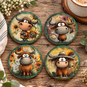 May include: A set of four circular coasters featuring illustrations of brown highland cattle with horns. Each coaster displays a different scene with sunflowers, floral elements, and script text on a textured background with green and yellow tones.
