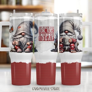 May include: Three white travel mugs with handles, featuring gnome illustrations. The gnomes hold mugs that say "NOPE." One mug has a butterfly. The mugs have a red striped bottom and the text "JUST SO WE'RE CLEAR IDK, IDC, OH YEAH & ALSO IDGAF."