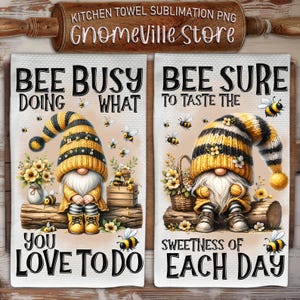 May include: Two kitchen towels with a gnome design. The first towel features a gnome with a bee-themed hat and the text "Bee Busy Doing What You Love To Do". The second towel features a gnome with a bee-themed hat and the text "Bee Sure To Taste The Sweetness Of Each Day".