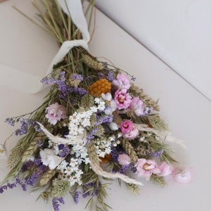 May include: A handmade wooden sign with the text "Welcome" in a playful font. The sign features a distressed white background and a dark brown border, perfect for a front door or entryway. The sign measures approximately 12 inches wide and 6 inches tall.
