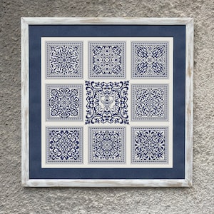 May include: A white frame with a navy blue mount surrounding nine white squares with blue geometric patterns. The patterns are intricate and symmetrical.