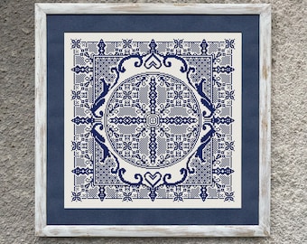 May include: A white framed embroidery design with a blue and white geometric pattern. The design features a central circle with a cross-like shape and intricate details.