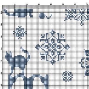 May include: A cross-stitch pattern featuring a blue and white design of a cat, snowflakes, and a floral pattern. The pattern is on a white background with a gray border.