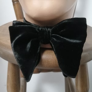 May include: A black velvet bow tie. The bow tie is tied and ready to wear.