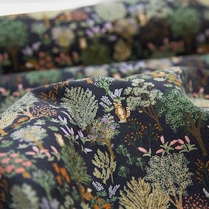 May include: Black fabric with a repeating pattern of green trees, flowers, and small animals. The fabric has a corduroy texture.
