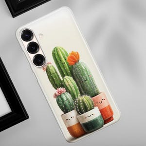 May include: A clear phone case featuring a whimsical illustration of several cartoon cacti in colorful pots. The cacti are various shades of green, with orange and pink flowers. The pots are white, orange, and green. The phone case has a camera and flash.