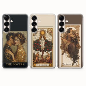 May include: Three phone cases with tarot card designs. The first case features a couple embracing, with the text "THE LOVERS." The second case depicts an angel under a sun, with the text "THE LOVERS." The third case shows a skeleton and woman, with the text "The Lovers."