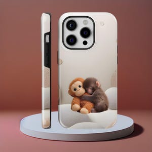 May include: A phone case featuring a digital illustration of two monkeys hugging. One is a plush toy, the other a real monkey. The case is white with a beige background and a side view showing a pattern of beige and white stripes.