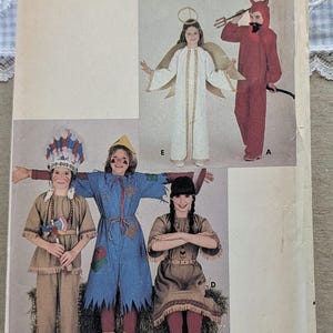 May include: A Butterick sewing pattern envelope, size medium, featuring illustrations of five different costumes: a white angel with gold wings, a red devil with a pitchfork, a tan fringe outfit with a headdress, a blue scarecrow, and a tan dress.