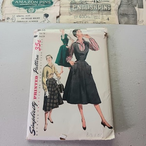 May include: Vintage Simplicity printed sewing pattern, size 18, featuring illustrations of women's dresses and skirts. The pattern packet is cream-colored with the text "Simplicity Printed Pattern" and "35c". Includes vintage pin packets.