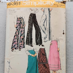 May include: Vintage Simplicity sewing pattern 5361 featuring illustrations of flared pants and skirts. The pattern includes a size 20 with a 34-inch waist. The cover is yellowed with age and shows various garment designs.