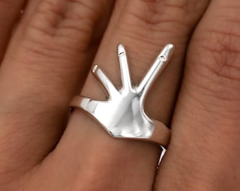 Ring shaped like a hand discount