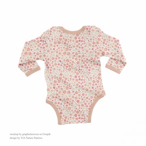 May include: A white baby onesie with a pink and green floral pattern. The onesie has long sleeves and a snap closure at the bottom.