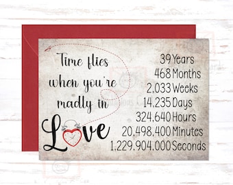May include: A vintage-style card with a red heart alarm clock and the text "Time flies when you're madly in Love" with a list of time units in years, months, weeks, days, hours, minutes, and seconds.