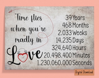 May include: A digital download print with a vintage background and a red alarm clock with a heart-shaped face. The text reads "Time flies when you're madly in Love" and lists the number of years, months, weeks, days, hours, minutes, and seconds in 39 years.