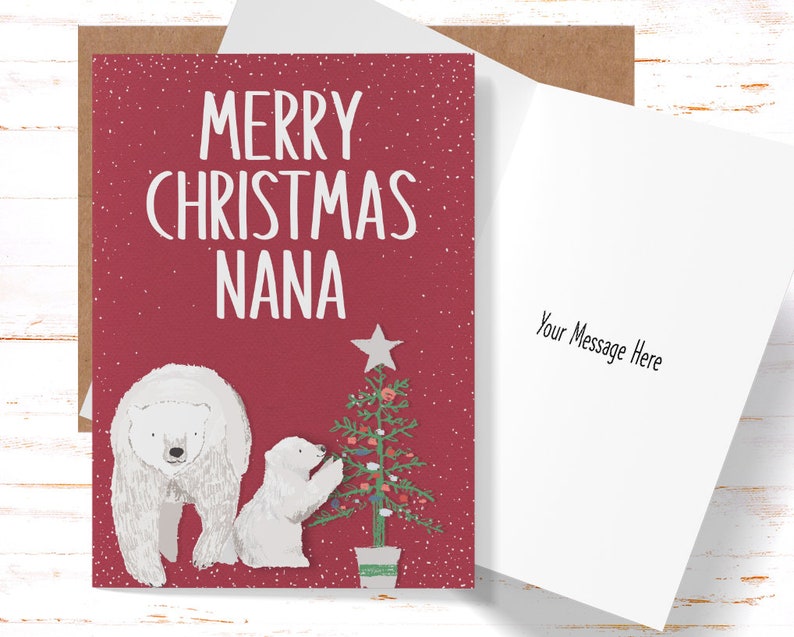 May include: A Christmas card with a red background and the text "MERRY CHRISTMAS NANA" in white. The card features illustrations of a polar bear and a baby polar bear decorating a Christmas tree. The inside of the card is blank with the text "Your Message Here".