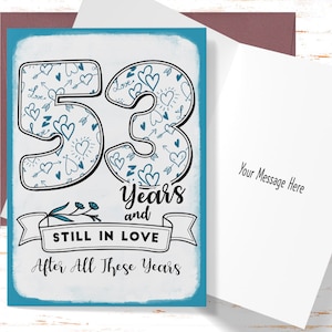 May include: A blue and white card with the number 53 in large, outlined font. The numbers are filled with a pattern of hearts and arrows. The text "Years and Still in Love After All These Years" is below the numbers.