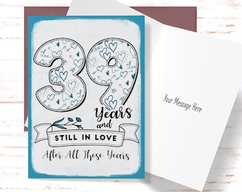 May include: A blue and white card with the number 39 surrounded by hearts and arrows. The card says "39 Years and Still in Love After All These Years".