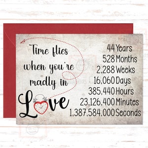 May include: A vintage-style card with a red heart alarm clock and the text "Time flies when you're madly in love" with a countdown of time in years, months, weeks, days, hours, minutes, and seconds.