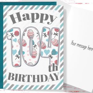 May include: A birthday card with a gray and blue striped background. The card says "Happy 104th Birthday" with the number 104 decorated with pink and blue cupcakes and candy.