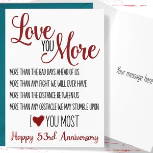 May include: A white card with a red and black cursive inscription that reads "Love You More" and "Happy 53rd Anniversary". The card also includes the text "More than the bad days ahead of us, More than any fight we will ever have, More than the distance between us, More than any obstacle we may stumble upon, I love you most".