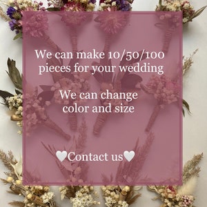 May include: Dried flower bouquets tied with twine, arranged on a white surface. The bouquets are made with various dried flowers and grasses in shades of white, cream, and beige. The text "We can make 10/50/100 pieces for your wedding. We can change color and size. Contact us." is displayed on a pink background.