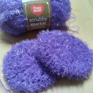 May include: Purple yarn with silver glitter, labeled "Red Heart Scrubby Sparkle" yarn.