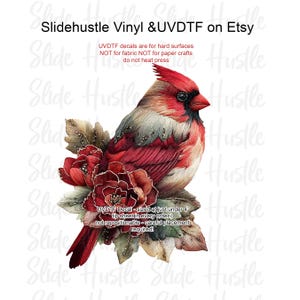 May include: A detailed illustration of a cardinal bird perched on a floral arrangement. The bird features red, white, and gray feathers, with a red crest and beak. The flowers are a deep red. Text on the image reads "Slidehustle Vinyl & UVDTF on Etsy."