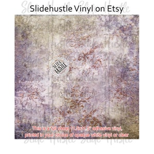 May include: Full sheet of 11.5x11.5 inch adhesive vinyl with a distressed floral pattern in shades of purple, brown, and gray. The text says "Slidehustle Vinyl on Etsy". The vinyl is available in opaque white or clear.
