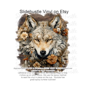 May include: A digital design featuring a wolf's face surrounded by fall-colored flowers. The design is approximately 3.75 inches by 3.75 inches and is printed on clear removable adhesive vinyl. The text "SIZES VARY SLIGHTLY" is included in the image.