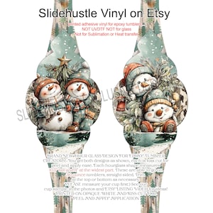 May include: Hourglass-shaped vinyl decals for epoxy tumblers. The design features two snowmen in winter attire, surrounded by a snowy forest scene. The text "Slidehustle Vinyl on Etsy" is at the top. Each decal is 10.5 inches tall and 3 inches wide.