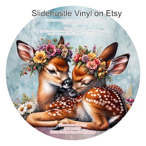 May include: Two deer fawns with floral crowns are cuddling. The deer are brown with white spots and are on a blue background. The image is for a vinyl sticker that is 9.5 or 10.5 inches in diameter. The text "Slidehustle Exclusive Designs" is in the background.