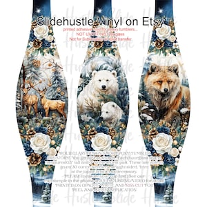 May include: Hourglass-shaped vinyl wrap for epoxy tumblers, featuring a winter forest scene with deer, polar bears, and a fox. The design includes white roses, pinecones, and text that reads "Slidehustle Vinyl on Etsy". Each wrap measures 10.5 inches tall and 3 inches wide.