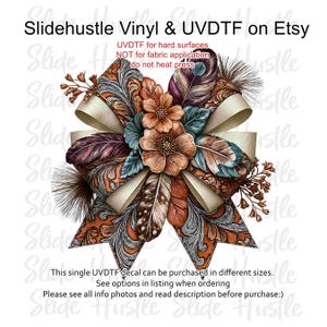 May include: A UVDTF decal featuring a decorative bow with intricate orange and silver filigree patterns, layered with brown and teal feathers, and central orange flowers. Text reads: Slidehustle Vinyl & UVDTF on Etsy, UVDTF for hard surfaces NOT for fabric application do not heat press, This single UVDTF decal can be purchased in different sizes. See options in listing when ordering Please see all info photos and read description before purchase:)