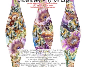 May include: Hourglass-shaped vinyl wrap for epoxy tumblers. The design features an underwater scene with fish, coral, and jellyfish in shades of purple, blue, and orange. Each wrap is 10.5 inches tall and 3 inches wide. Text on the wrap reads "Slidehustle Vinyl on Etsy."