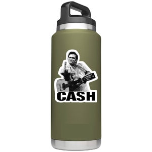 May include: A green insulated water bottle with a black lid and handle. A sticker of Johnny Cash giving the middle finger while playing a guitar is on the bottle. The sticker also has the word "CASH" in black letters.